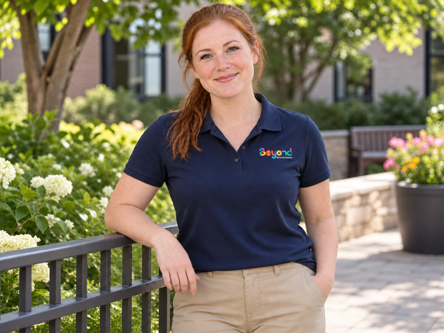 Fictional staff-photo placeholder: a woman wearing a navy BBS polo.